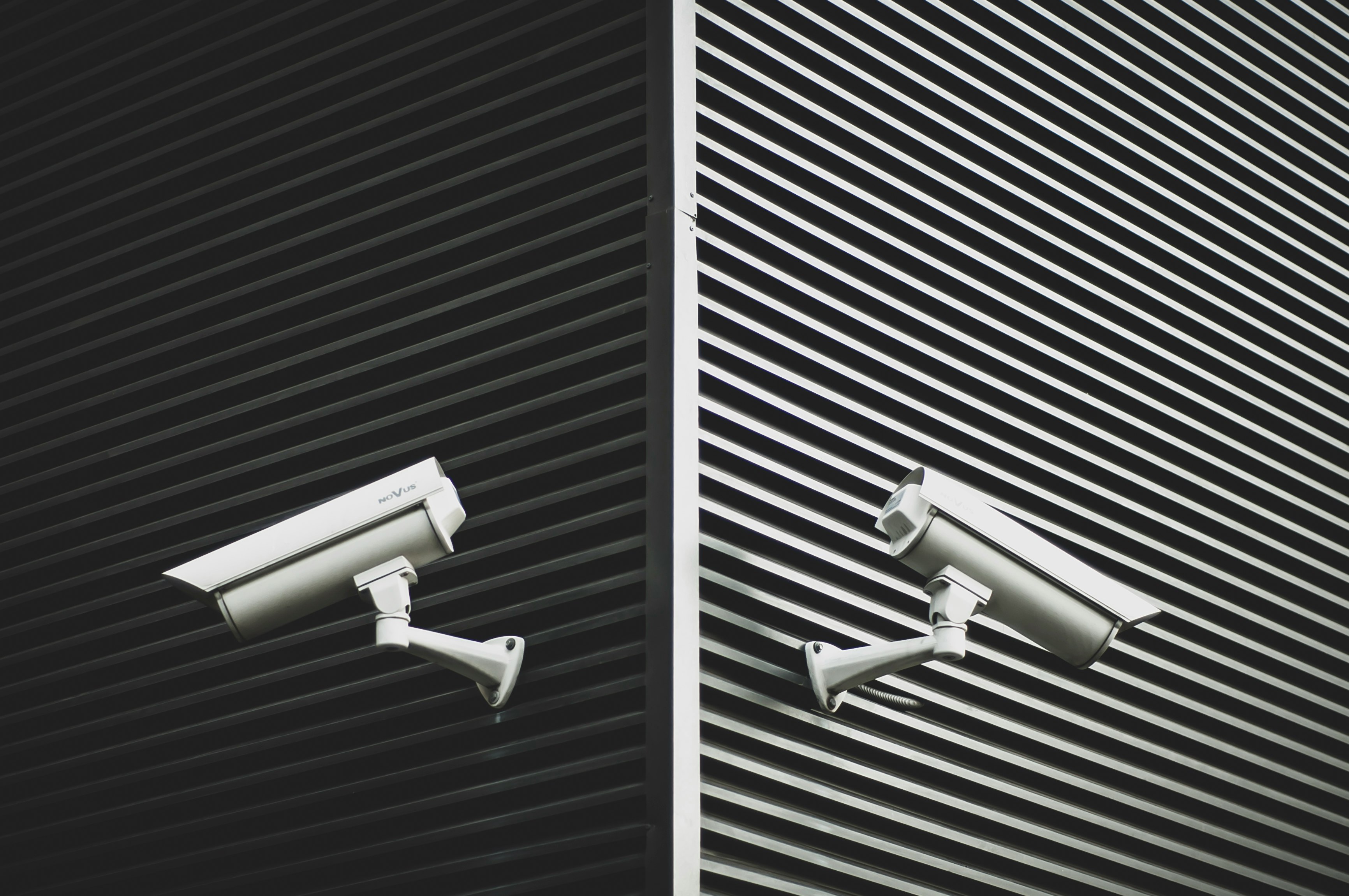 Two grey CCTV cameras